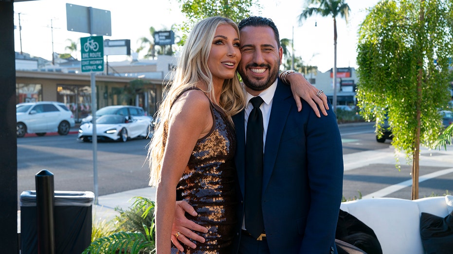 Heather Altman with her arm around Josh Altman