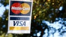 MasterCard and Visa logos are seen near a shop in Washington DC, United States on October 20, 2022 